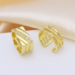 Minimalist gold-plated zircon ring set with geometric layers on silk background