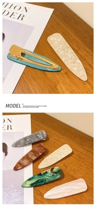 Close-up of French vintage acetate duckbill hair clips in various marble textures