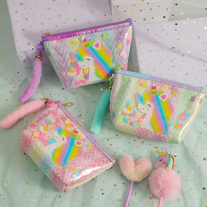 Three gradient glitter unicorn makeup bags in pink, purple and green with fuzzy charms