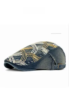 Detail of washed denim beret with contrast embroidery and vintage metal buckle