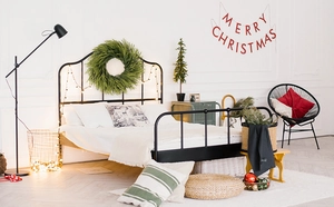 Christmas bedroom decor with Norfolk pine garland and festive Merry Christmas wall banner