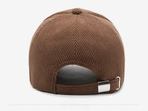 Close-up of brown corduroy baseball cap back with adjustable silver metal buckle strap