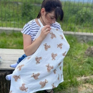 Detail of cotton nursing cover with brown bear print and textured muslin fabric