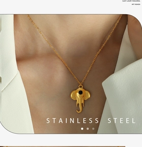 Macro shot of gold elephant pendant necklace in stainless steel on a model