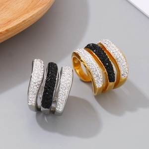 Three-layer geometric ring in gold and silver with black and white cubic zirconia stones