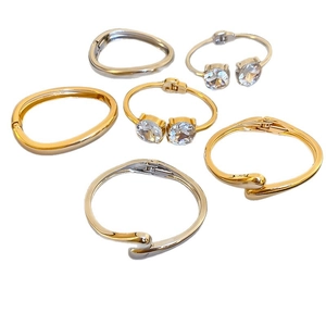 Set of minimalist gold and silver teardrop open bracelets with sparkling crystal accents