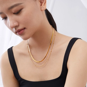 Double-layered gold titanium steel snake chain necklace for women on a model