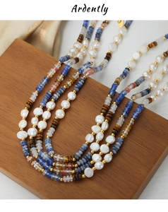 Detail of bohemian multilayer necklace with freshwater pearls, blue stones and gold beads