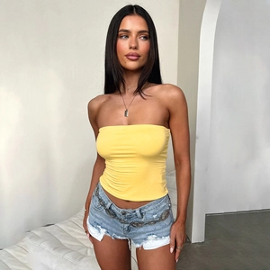 Slim fit yellow tube top paired with denim shorts and metal waist chain accessory