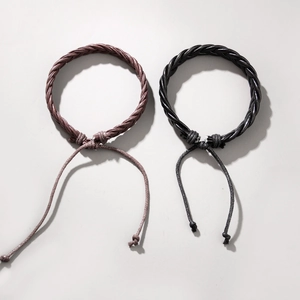 Minimalist handmade braided leather bracelet in black and brown with adjustable cord