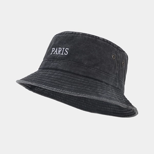 Close-up of PARIS letter embroidery on washed black cotton fisherman hat with eyelets