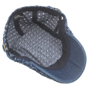 Detail view of cotton denim flat cap showing inner mesh weave and 100% cotton label