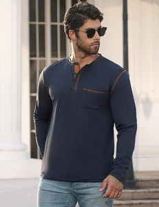 Close-up of navy blue long sleeve Henley shirt with contrast brown trim and pocket detail