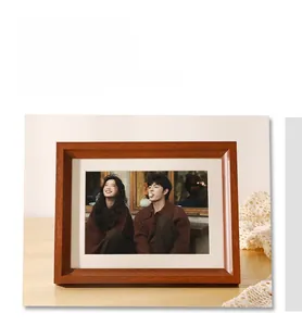Detailed view of wide solid wood photo frame with natural grain and white mat board