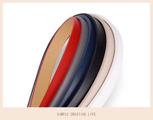 Close-up of slim leather waist belts in multiple colors including red, gray and blue