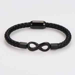Detail of black braided leather bracelet with infinity symbol and magnetic clasp