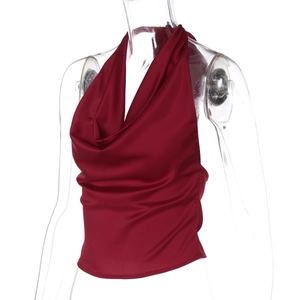 Macro view of burgundy satin halter top with glossy finish on a transparent mannequin