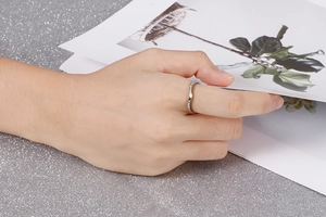 Gros plan sur une bague pavée scintillante en forme de V avec pierres blanches