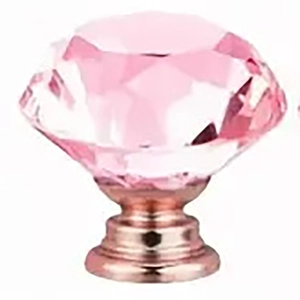 Detailed view of a pink crystal drawer knob with a rose gold base for cabinet furniture