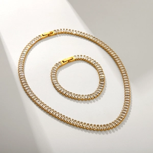 Gold stainless steel necklace and bracelet set featuring clear rectangular zircon crystals