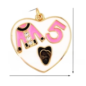 Macro shot of white enamel heart pendant with pink jacket and camellia floral details