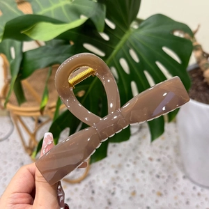 Large mocha brown bow hair claw clip with elegant butterfly design for thick hair styling