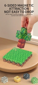 Macro shot of magnetic pixel cubes with sandbox textures being built by hand