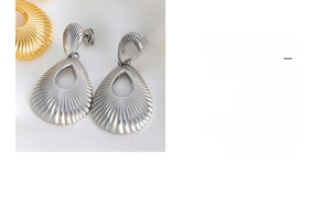 Detailed view of hollow teardrop earrings with radial texture in 18K gold and titanium steel