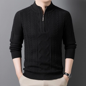 Detail of men's black knit sweater with half-zip stand collar and cable knit texture