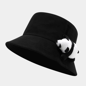 Detail shot of black cotton bucket hat featuring a 3D cute plush panda doll decoration
