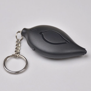 Macro detail of leaf-shaped personal safety alarm with durable metal keychain ring