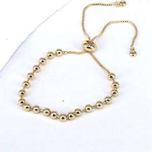 Adjustable minimalist gold beaded bolo bracelet with smooth round beads and sliding clasp