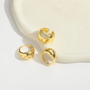 Three gold open rings featuring crystal paving, colorful gemstones, and star-shaped accents