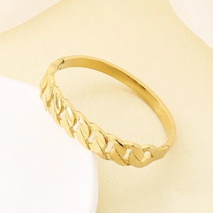 Detail of gold-plated stainless steel knot bangle with vintage wave design and clasp