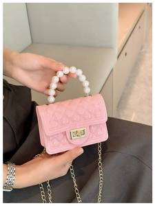 Pink jelly handbag with pearl handle, diamond texture, and metal chain shoulder strap