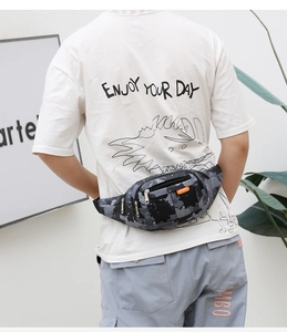 Detail of camouflage tactical waist bag with orange sport label on model back