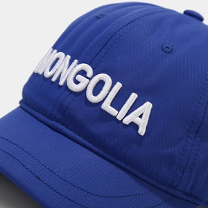 Close-up of white MONGOLIA 3D embroidery on royal blue cotton twill short brim cap