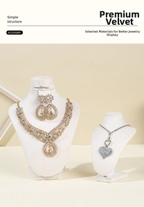 Detail of premium white velvet jewelry bust set with gold necklace and diamond earrings