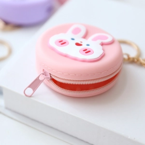 Close-up of pink round silicone coin purse featuring a cute 3D bunny and metal keychain