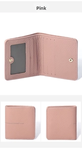 Detail view of pink leather wallet with multiple card slots and secure snap closure