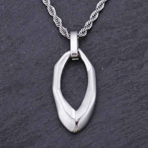 Macro shot of silver teardrop titanium steel pendant on twist chain over stone background