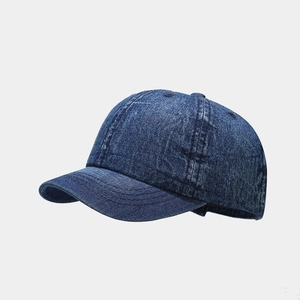 Macro view of washed dark blue denim baseball cap with reinforced stitching details