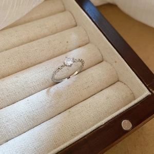 Silver adjustable ring with a brilliant round zircon stone set in a luxury display case