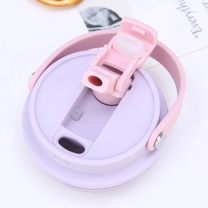 Detail of 30oz tumbler lid with purple and pink silicone straw and handle mechanism