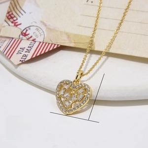 Macro detail of gold plated heart pendant necklace with white cubic zirconia stones