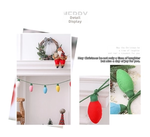 Close-up of colorful knitted Christmas bulb ornaments on a green crochet string