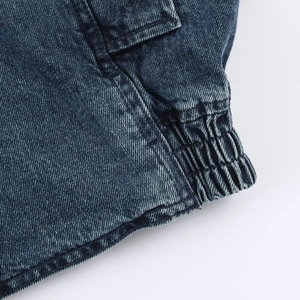 Detailed macro view of elasticated ribbed cuffs on vintage washed denim jacket