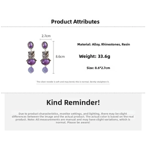 Detail view of vintage cat drop earrings with dimensions 8.6x2.7cm and purple resin stones