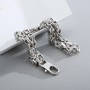 Detailed close-up of a silver Byzantine stainless steel chain bracelet for men