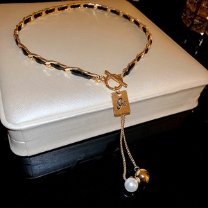 Elegant gold chain leather pearl necklace with OT clasp and Ori engraved tag on a box